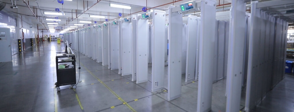line of white security metal detector walk-through gates